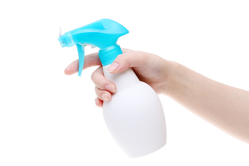 Hand holding spray cleaner plastic bottle on white background