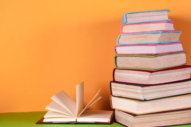 istock Open book, hardback books on bright colorful background. 664946618
