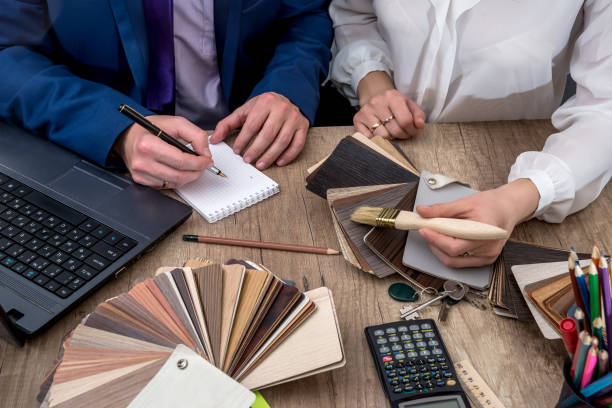istock Architect concept -  two architects working with blueprints in the office. 664947294