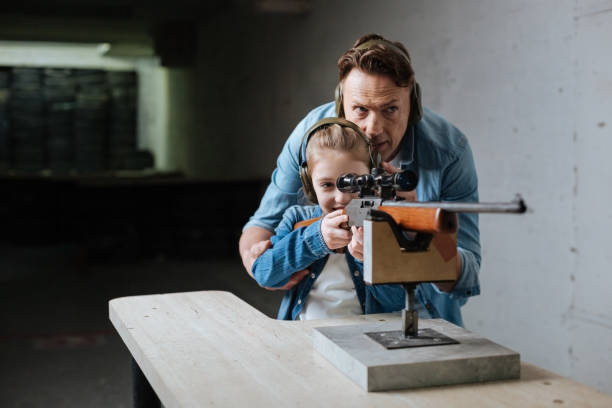 istock Nice delighted father and daughter visiting the shooting range 664947868