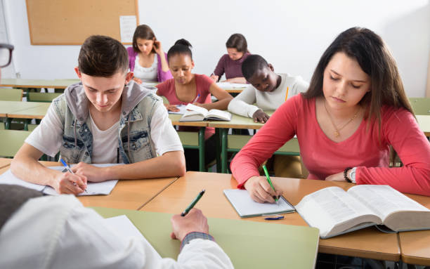 istock Enthusiastic girls and boys taking the notes while 664947972