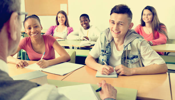 istock Enthusiastic girls and boys taking the notes while 664947982