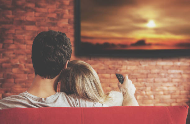 istock Smart tv and young couple pressing remote control. 664951228