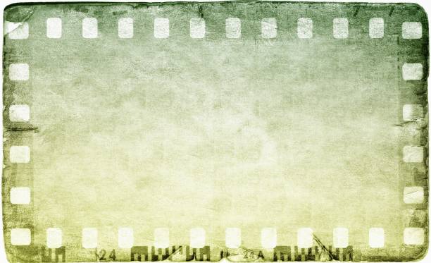 istock Vintage green film strip frame on old and damaged paper background. 664953760