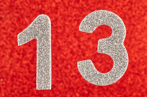 Number thirteen silver color over a red background. Anniversary. Horizontal