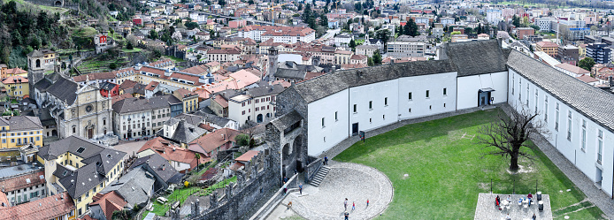 people walking on the walls of Castelgrande castle at Bellinzona on the Swiss alpspeople walking on the walls of Castelgrande castle at Bellinzona on the Swiss alps