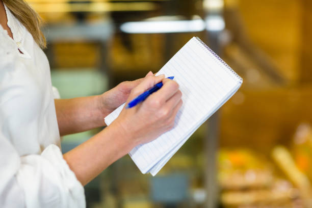 istock Woman checking list at supermarket 664959460