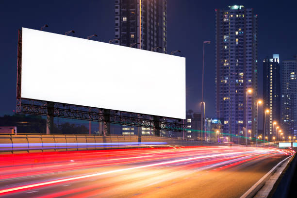 istock Blank billboard on light trails, street in night for advertisement. 664962092
