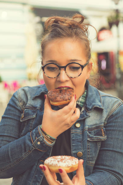 istock Beautiful girl holding sweets and colorful donuts. 664962542