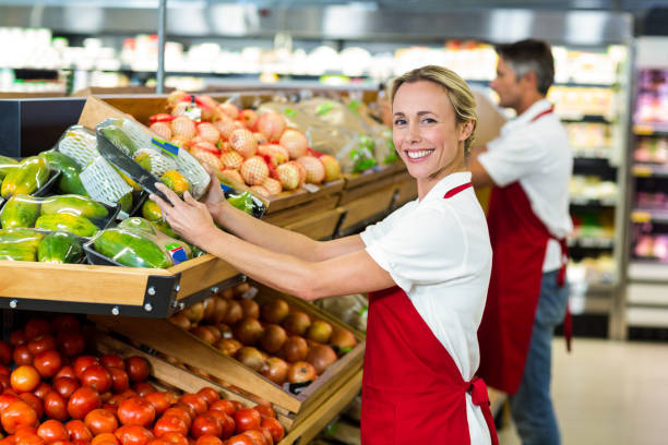 istock Smiling woman filling vegetables boxes 664963158