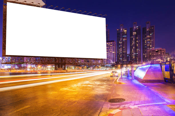 istock blank billboard on light trails, street and urban in night. 664963424