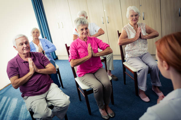 istock Group of seniors doing exercises with nurse 664966154