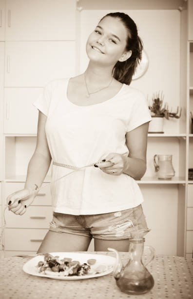 istock girl with measuring tape 664966304