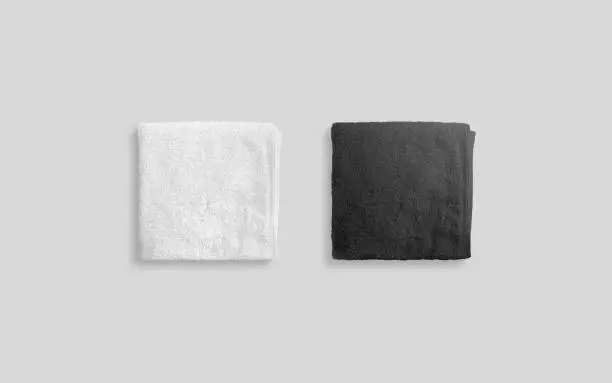 Blank black and white folded soft beach towel mockup. Clear wrapped wiper mock up laying on the floor. Shaggy fur bath textured jack-towel top view. Domestic cloth kitchen overlay template