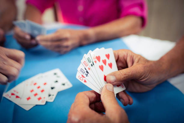 istock Group of seniors playing cards 664966634