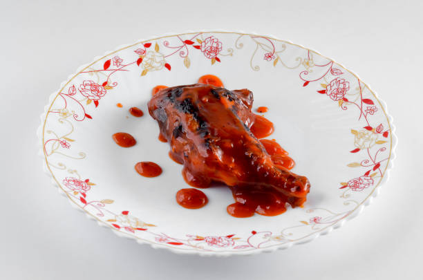 istock Traditional roasted chicken on floral plate over white background 664966942