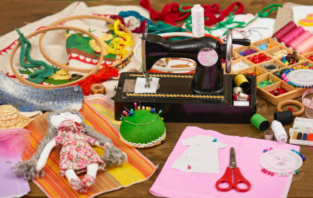 istock handmade doll and clothing pattern, sewing accessories top view, seamstress workplace, many object for needlework, embroidery and handicraft 664967112
