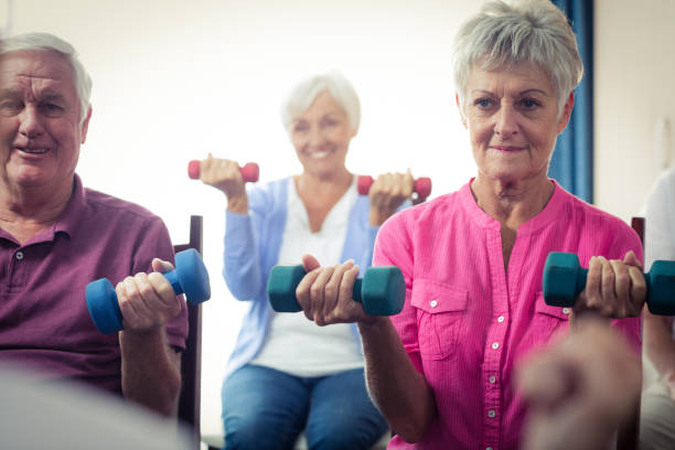 istock Group of seniors doing exercises with nurse 664967208