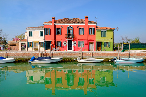Burano is an archipelago of four islands linked by bridges in the Venetian Lagoon, well known for its lace work and brightly coloured houses. Venice, Italy