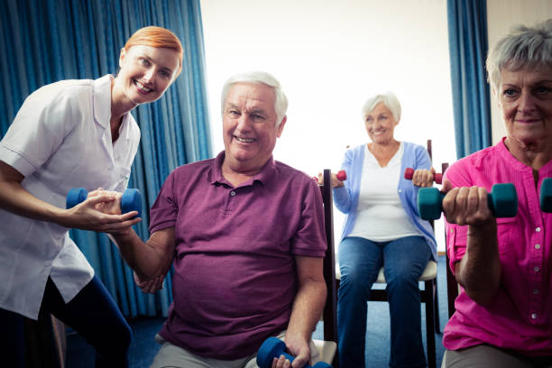 istock Group of seniors doing exercises with nurse 664967738