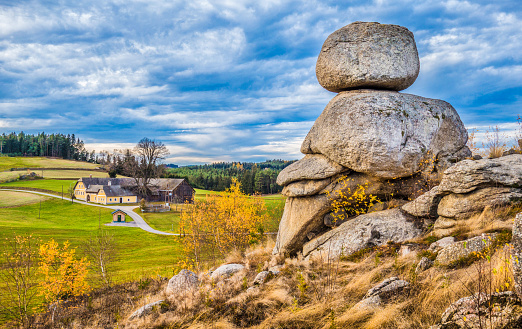 Panoramic view of beautiful rural scenery of idyllic Waldviertel region with famous Wackelsteine rocking stones and traditional farmhouse at sunset, Lower Austria state, Austria