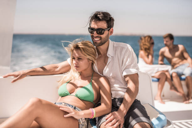 istock Young couple enjoying in summer day on a boat. 664971678