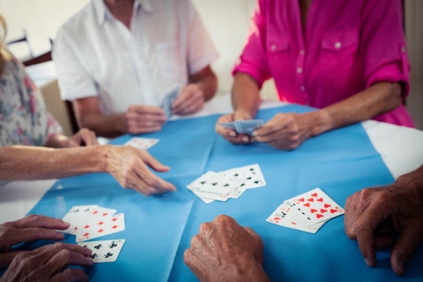 istock Group of seniors playing cards 664972072