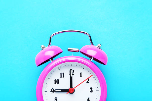 istock Pink alarm clock on the mint background 664972980