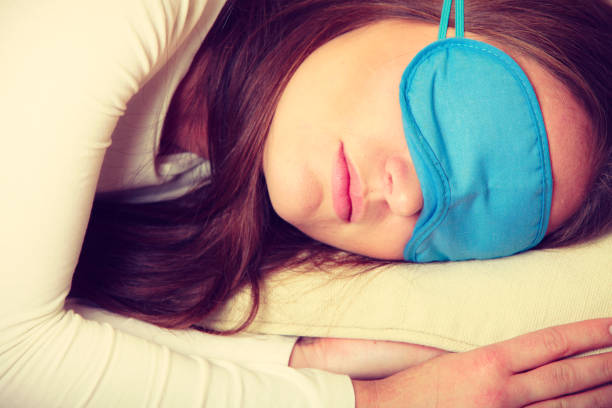 istock Brunette woman sleeping in blue eye sleep mask 664972994