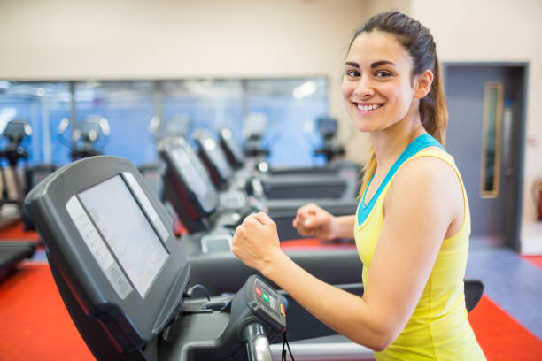 istock Smiling woman running on a treadmill 664976506