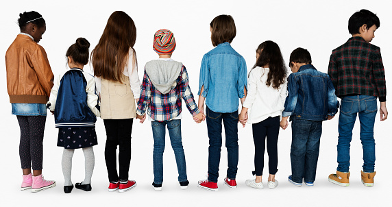 Group of diverse kids students standing in a row holdings hands