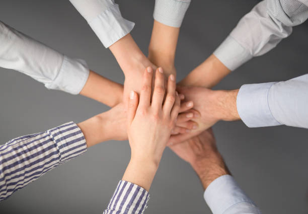 istock Hands stacked in a pile. A symbol of teamwork and trust. 664979618
