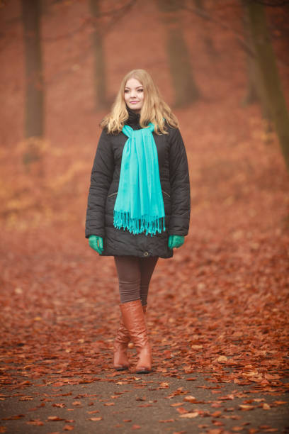 istock Attractive woman in autumnal park. 664980210