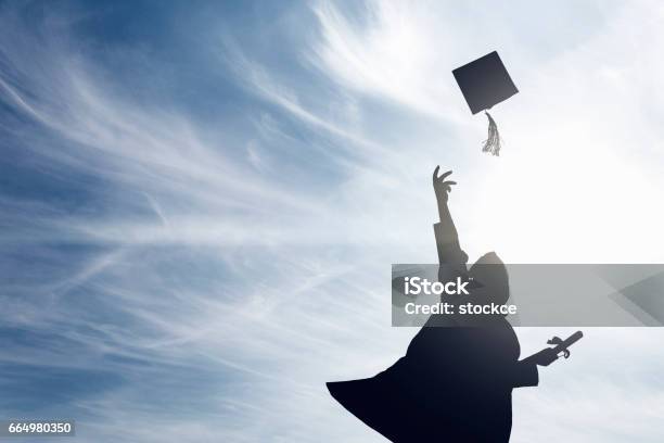 Graduate Students Tossing Up Hats Over Blue Sky Stock Photo - Download Image Now - Graduation, High School, University