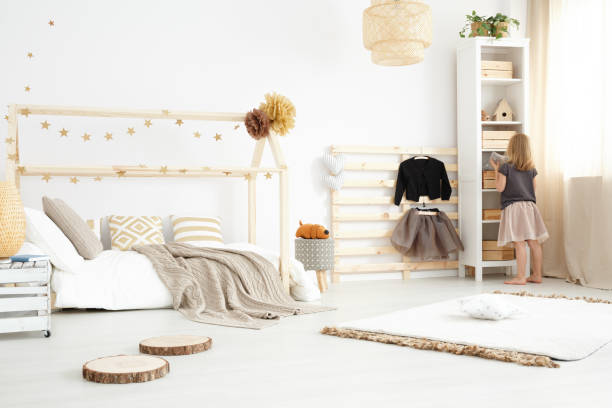 Scandi bedroom design Little girl standing in a bedroom designed in scandi style nordic walking pole stock pictures, royalty-free photos & images