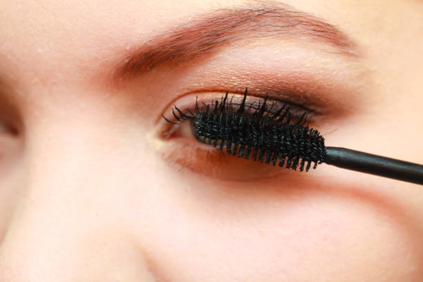 istock Close up woman getting make up, mascara 664986832