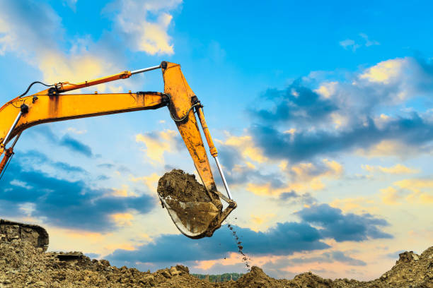 istock excavator in construction site on sunset sky 664987998