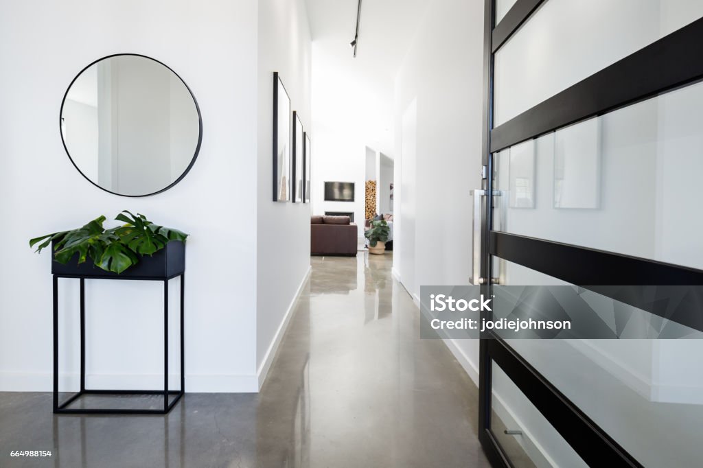 Contemporary home entry hall with polished floors Contemporary home entry hall with polished concrete floors Entrance Hall Stock Photo