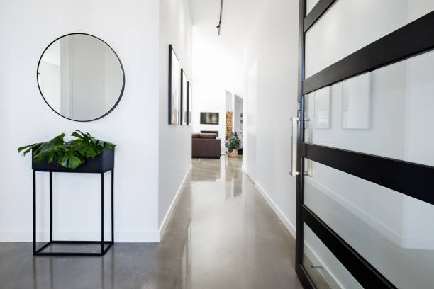 Contemporary home entry hall with polished floors Contemporary home entry hall with polished concrete floors entrance hall stock pictures, royalty-free photos & images