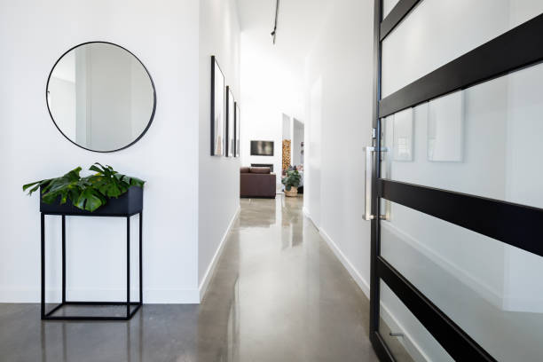 Contemporary home entry hall with polished floors Contemporary home entry hall with polished concrete floors corridor stock pictures, royalty-free photos & images