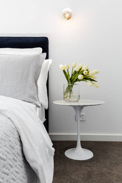 Close up of tulips on a marble bedside table