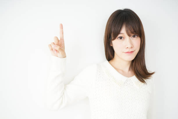 istock Young woman pointing something with smile 664991268