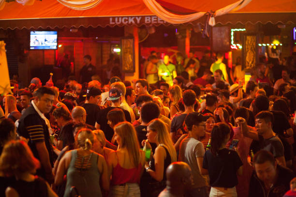 Dancing and party scene in Khao San Road Dancing and paryt scene in Khao San Road at deep night. View from one bar to next bar with name Lucky Beer. Crowd of people is dancing and drinking alcohol. khao san road stock pictures, royalty-free photos & images