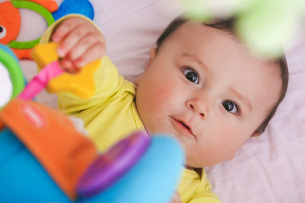 istock Baby lying in his crib staring at camera surpised 664994464