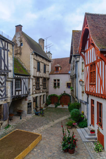 Square with half-timbered houses, in the medieval village Noyers-sur-Serein Sunrise view of a square (place de la petite etape aux vins), with half-timbered houses, in the medieval village Noyers-sur-Serein, Burgundy, France avallon stock pictures, royalty-free photos & images