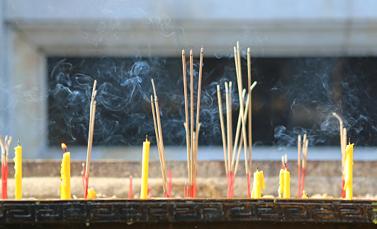 Burning incenses in the incense pot in the temple