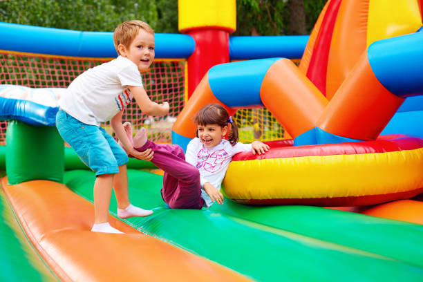 istock happy kids having fun on inflatable attraction playground 665005542