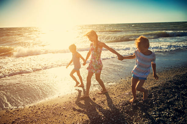 istock Kids walking at the tuscan beach 665006352