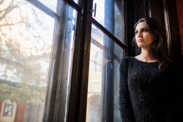 istock Pretty woman looking out the window 665009112