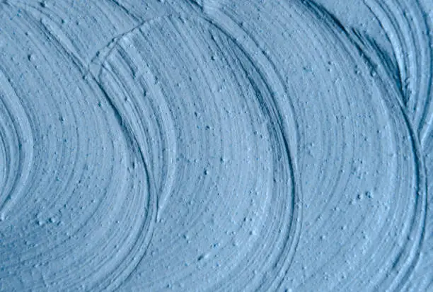 Photo of Blue cambrian cosmetic clay (facial mask, cream) texture close up, selective focus. Abstract background.